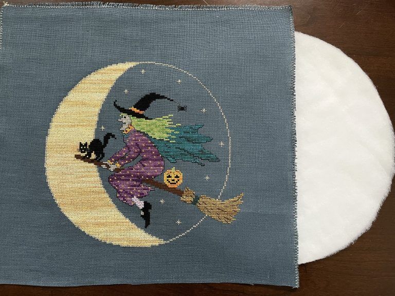 stitched witch mounted over batting-covered circle